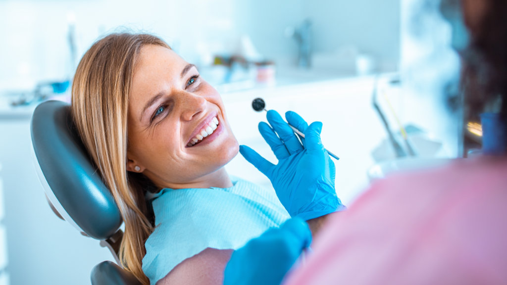 Smiling woman in a dental chair during a preventive dental checkup